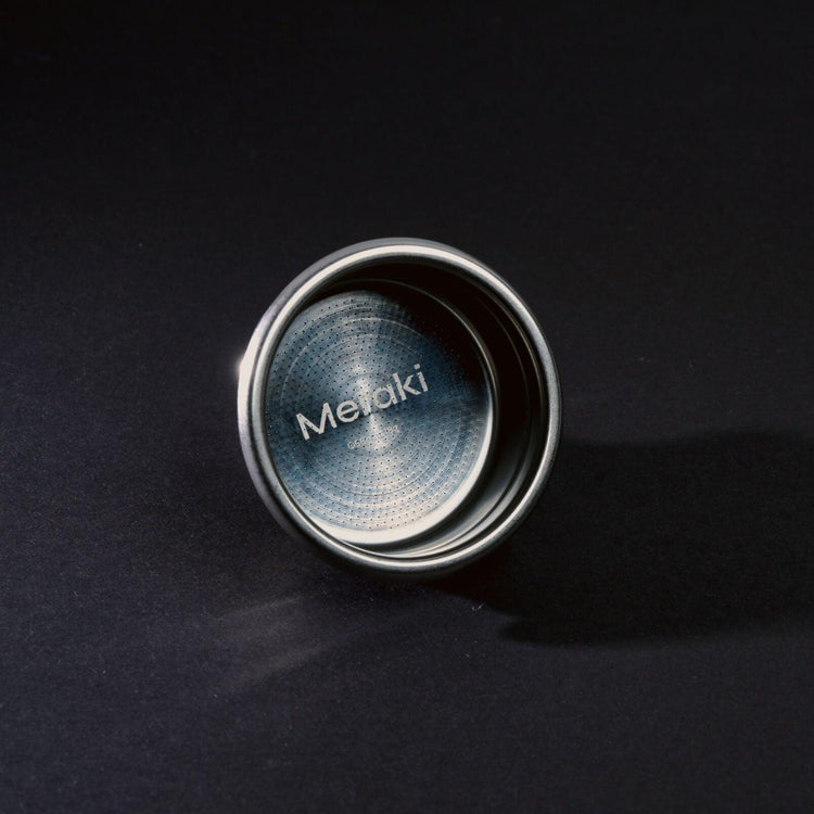 Meraki 58mm portafilter basket, 18g, stainless steel construction, precise perforations, engraved logo.