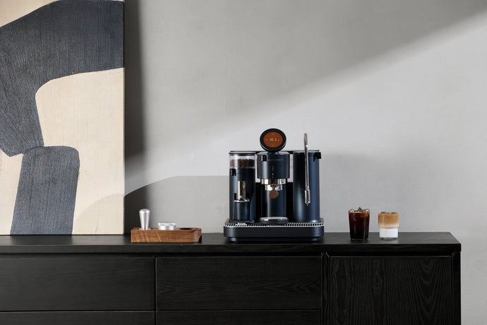 A dual boiler espresso machine showing simultaneous brewing and steaming capability.