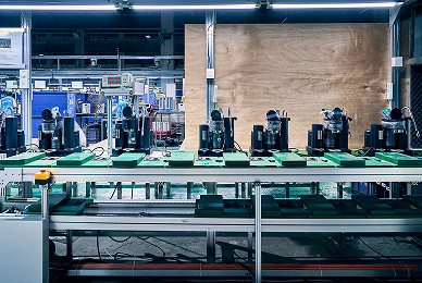 Espresso machines on assembly line in modern factory, precision-engineered for home brewing