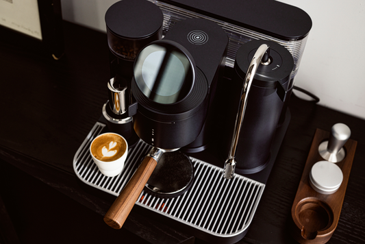 A modern, high-end espresso machine setup with various accessories and a beautifully crafted latte art.
