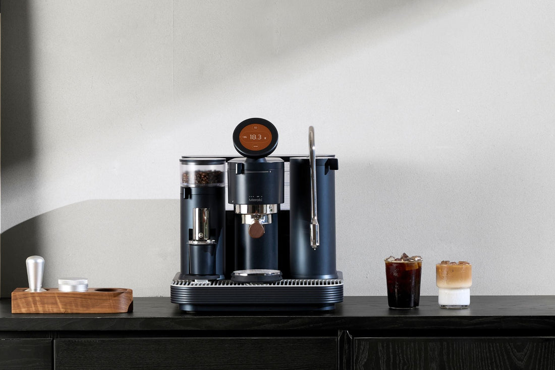 Meraki espresso machine on a kitchen counter with two espresso drinks and a minimalist background