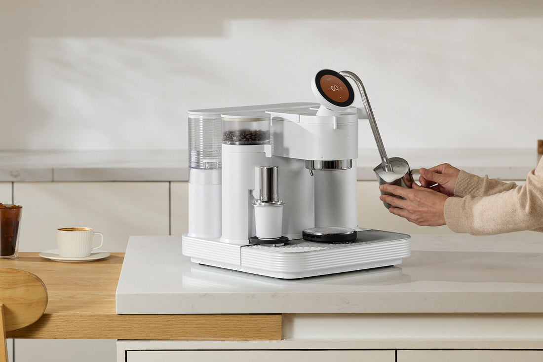 A person uses a white smart home espresso machine with grinder and milk frother for best quality coffee.