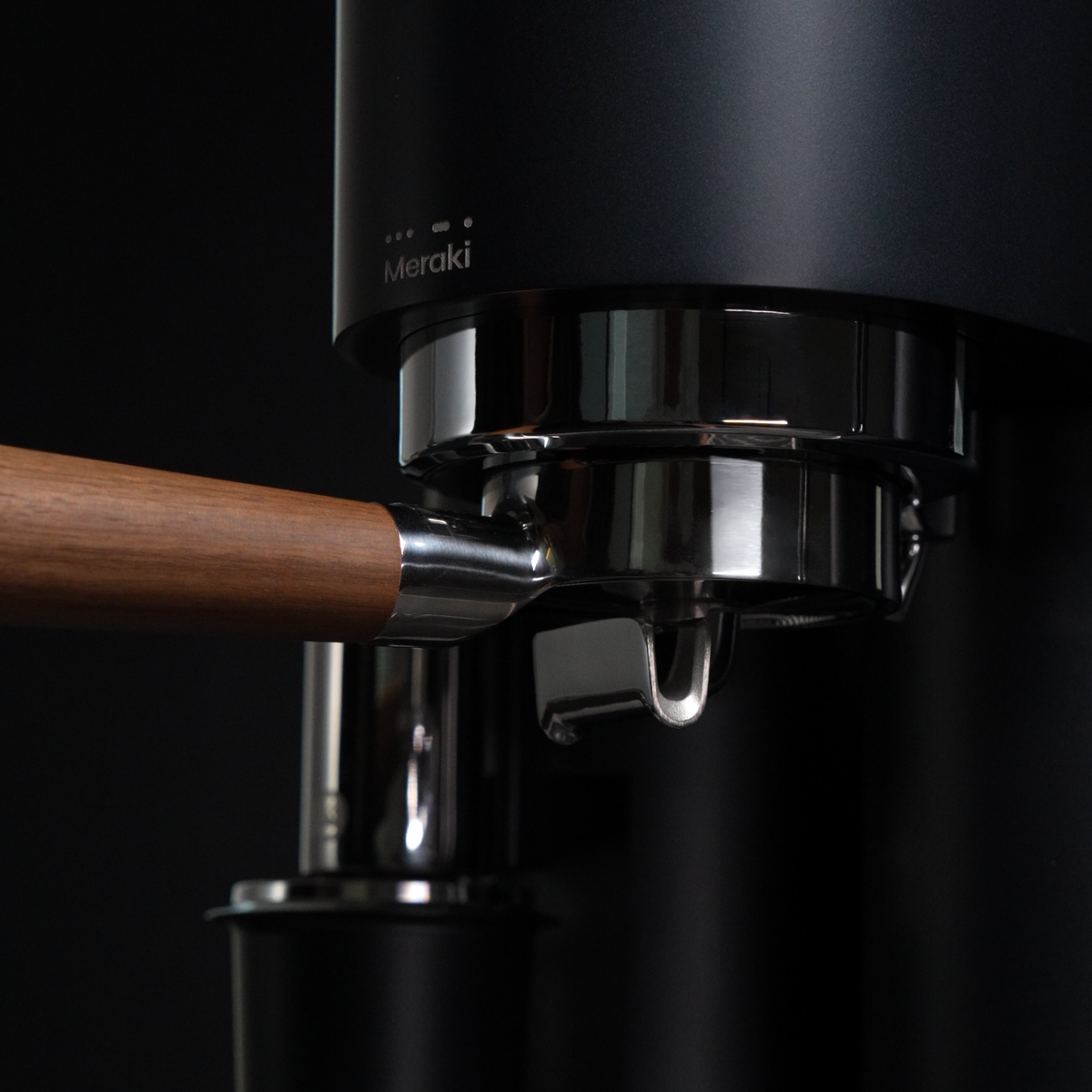 Black Meraki espresso machine with walnut portafilter handle