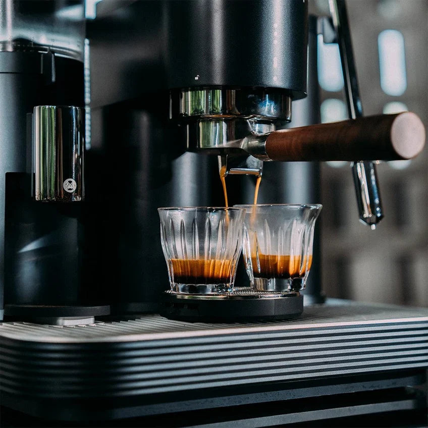 Meraki espresso machine pouring espresso into two glasses through a double-spout portafilter