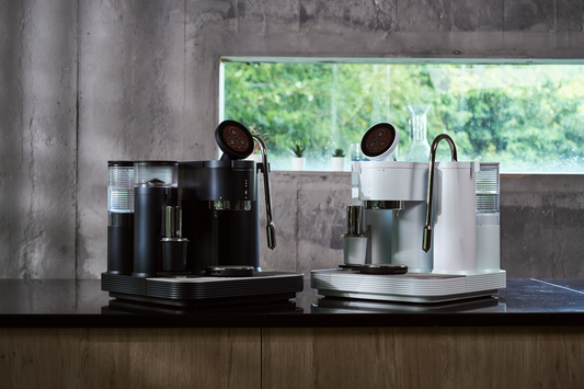 Black and white Meraki espresso machines displayed side by side