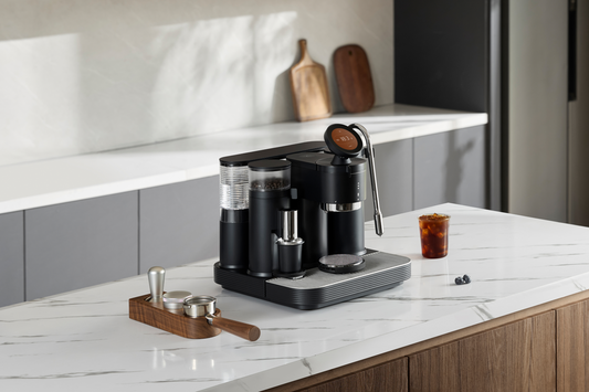 Black Meraki espresso machine on a marble kitchen island