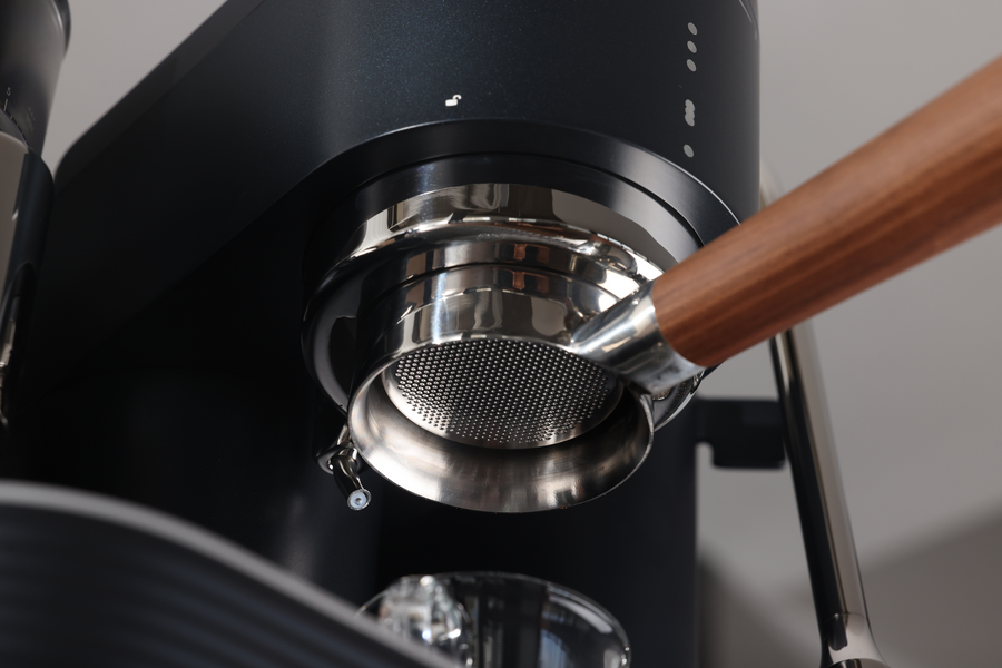Close-up of a bottomless portafilter fitted to a Meraki espresso machine