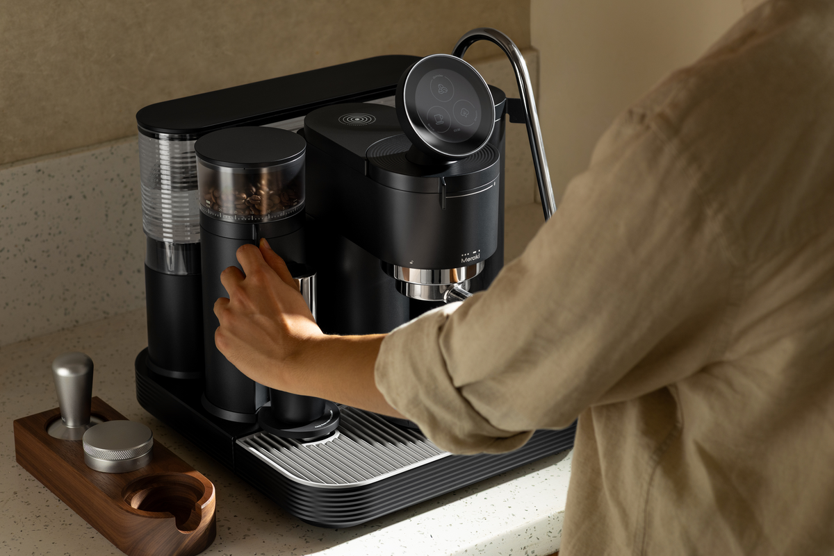 Using the grinder controls on a black Meraki espresso machine