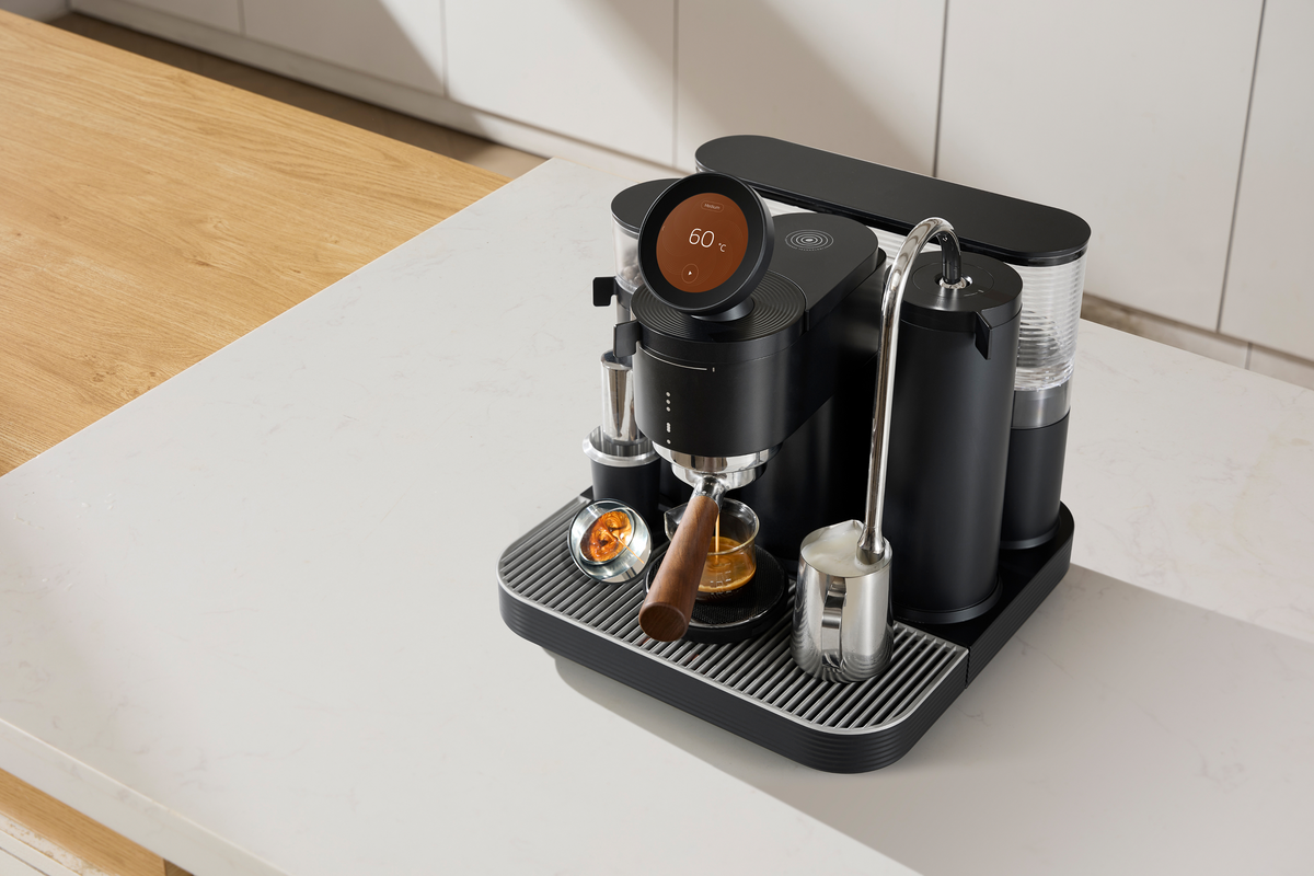 Overhead view of a black Meraki espresso machine with a prepared coffee