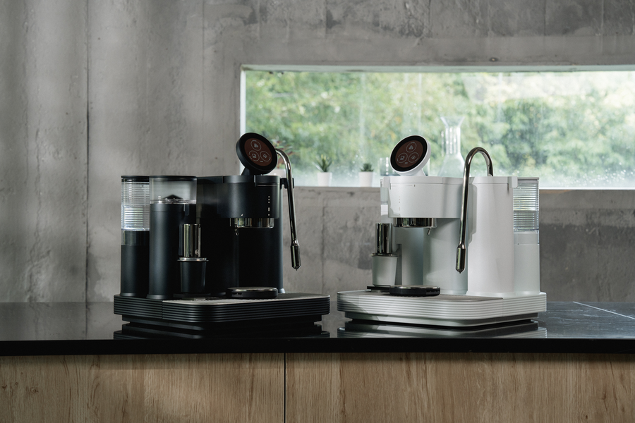 Black and white Meraki espresso machines displayed together