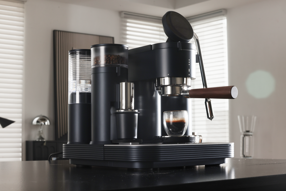 Angled view of a black Meraki espresso machine in natural light