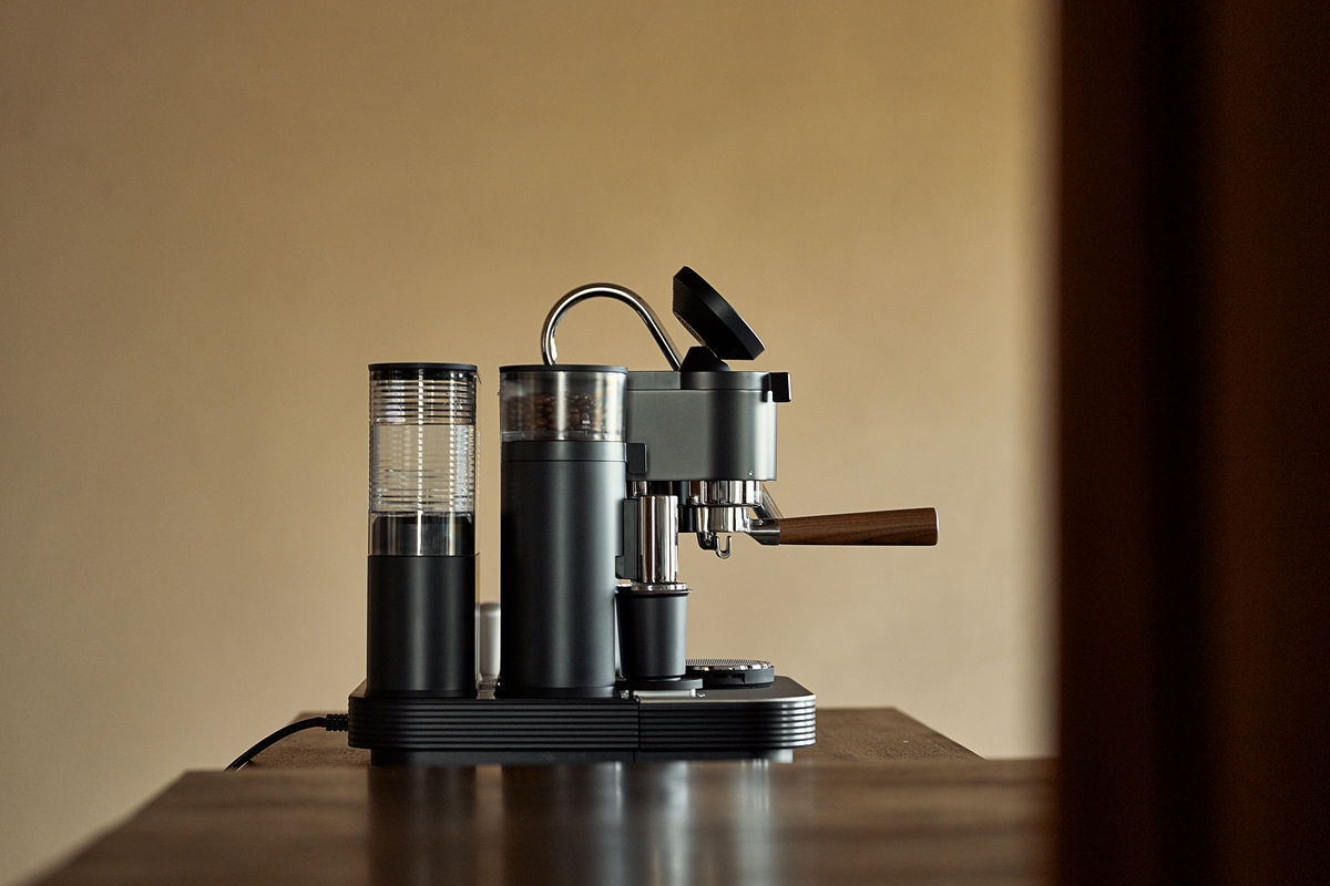 Black Meraki espresso machine and portafilter shown from the side