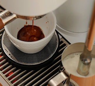 Close-up of the Meraki dual boiler espresso machine, showcasing its high end home espresso machine build quality and integrated gravimetric scale for precision brewing.