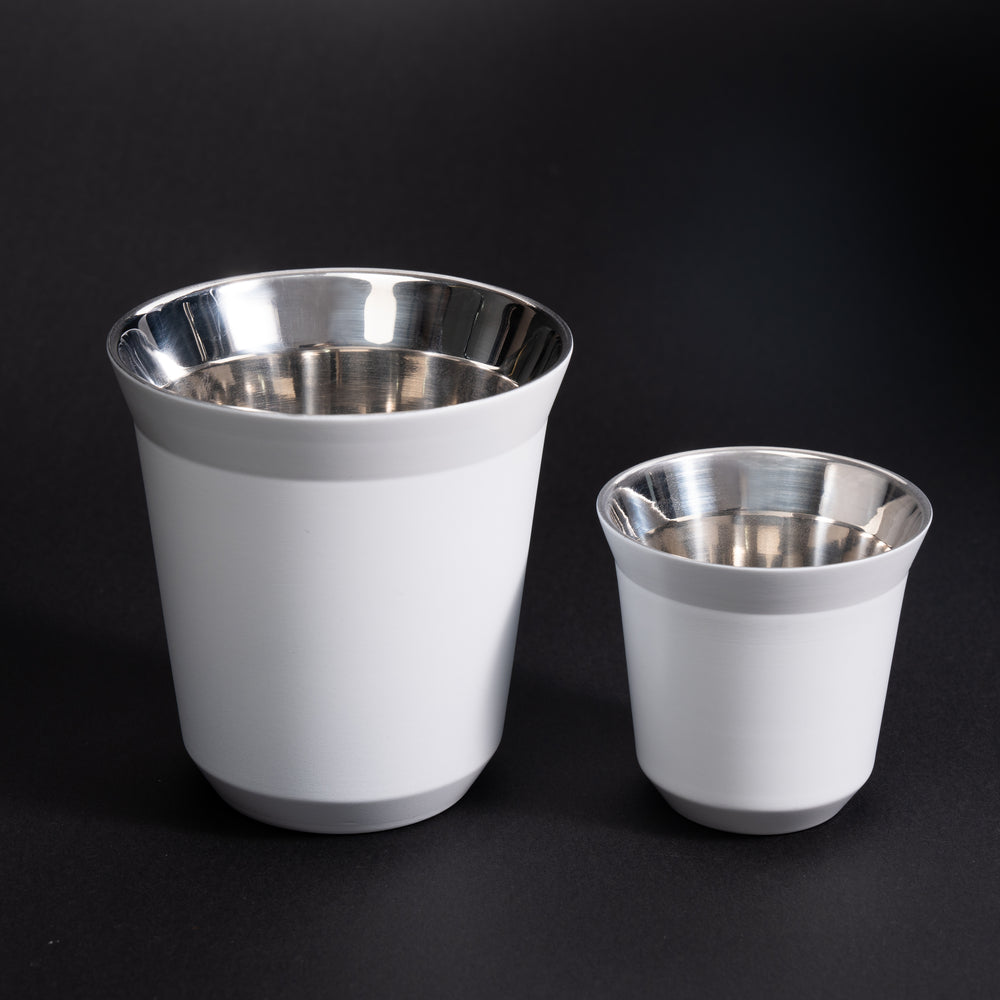 White Meraki espresso and latte cups with metal interiors