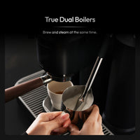 Dual boiler espresso machine pulling an espresso shot while steaming milk at the same time