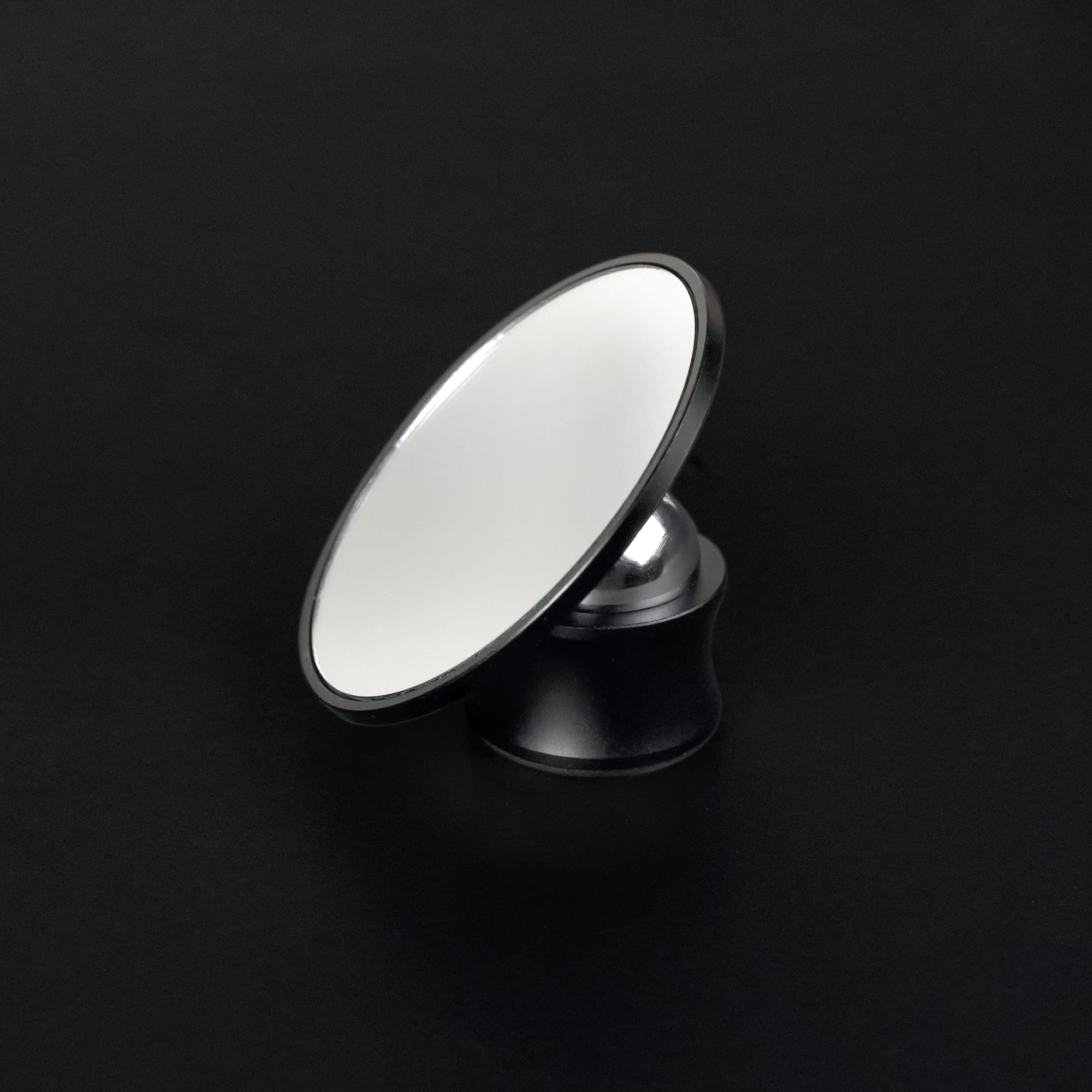 Round Meraki espresso shot mirror on an adjustable black stand