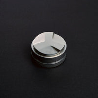 Stainless steel coffee distributor for even grounds distribution in espresso preparation.