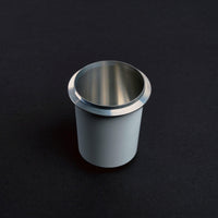 Meraki white dosing cup with polished stainless steel rim.