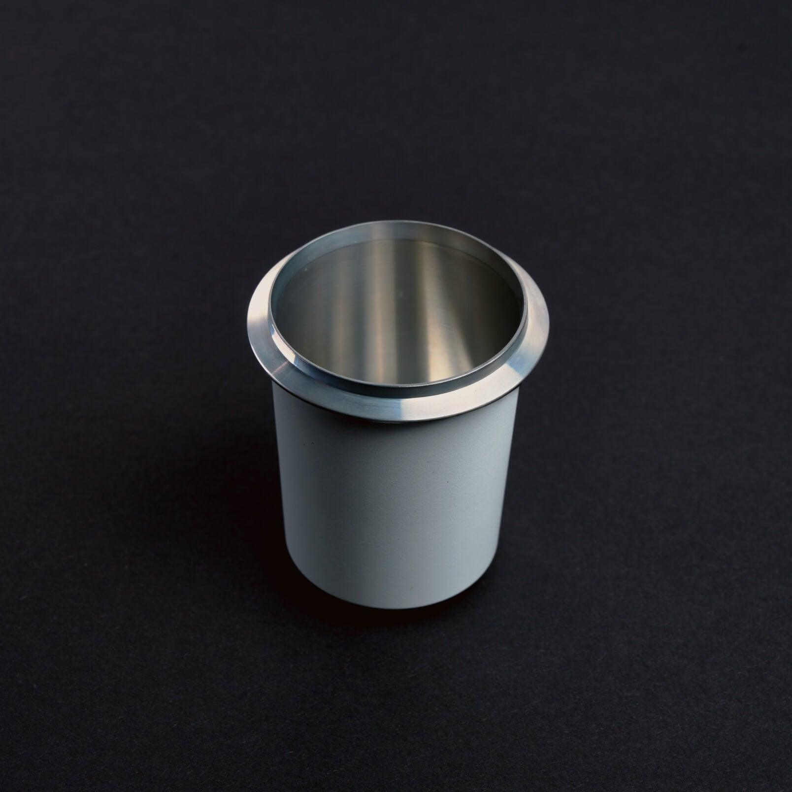 White Meraki dosing cup with polished rim for clean espresso ground transfer