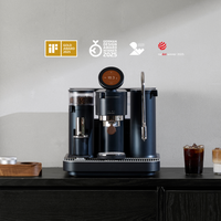 Meraki professional espresso machine with award logos and iced coffee on a black counter