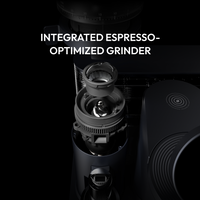 Close-up of an integrated espresso-optimized coffee grinder mechanism in a sleek black machine.