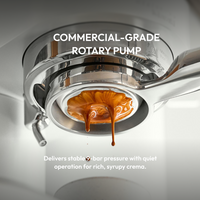 Close-up of rich, syrupy espresso crema pouring from a commercial-grade rotary pump machine.
