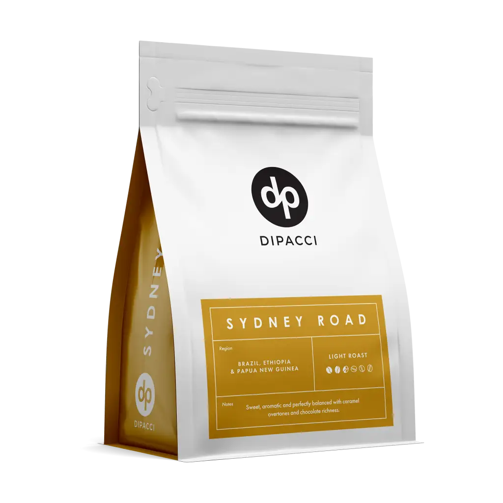 Dipacci Sydney Road light roast coffee beans in a white and gold pouch